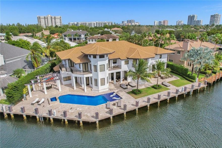 Every detail in this carefully curated modern waterfront estate personifies elegance, culture, Art & a unique depth of design. Situated on a cul-de-sac and stretched across 170’ of waterfront in the elite private and man-gated Bay Colony. This home is the creation of renowned designer Lori Morris and has been featured in Florida Design Magazine. Exceptional selections of materials, lighting, and colors blend creating a space that is both glamorous and comfortable for the owners and their guests. Estate features 2 docks, 8 suites, 9.5 baths, an Italian kitchen w/Top of the line appliances, fitness/spa room, entertaining lounge, executive office, VIP suite, Captain's Suite, 1,600sf Master, a 27' high dome ceiling foyer. 10,000 interior sf, on an oversized lot of 19,000 sf.