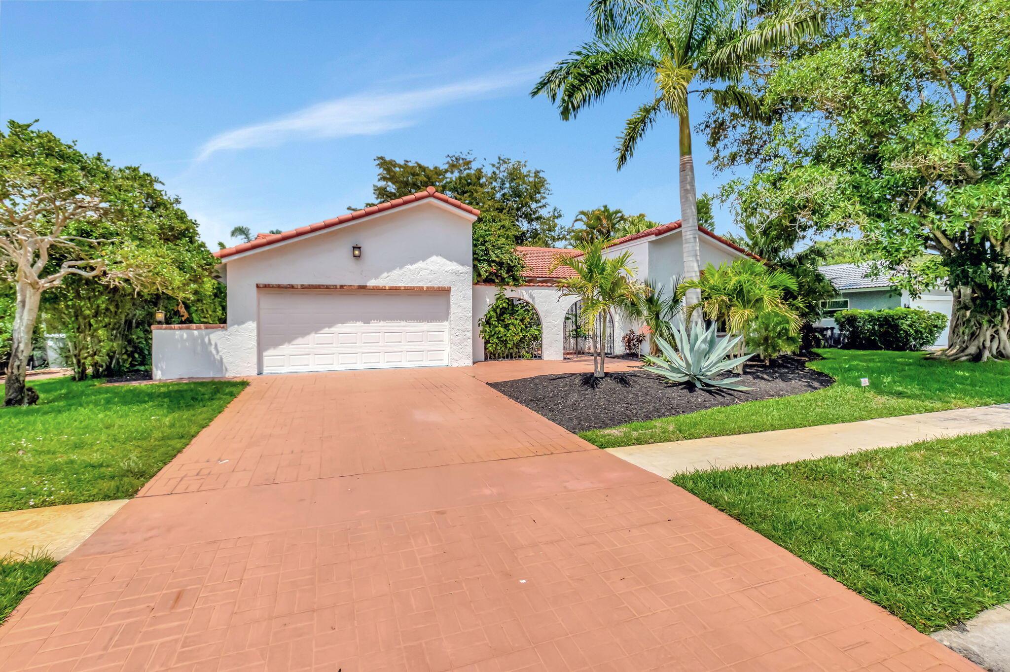 This is the South Florida lifestyle at its finest in the exclusive gated community of Boca Greens! Behind a charming gated courtyard entry, this beautifully staged pool home welcomes you with warmth, style & an abundance of upgrades. From the moment you arrive, you'll notice the attention to detail--from the fresh new backsplash and designer hardware to the new lighting fixtures that elevate every room. This light-filled residence offers just over 2,300 sq ft of elegant living space with soaring ceilings, Luxury Vinyl flooring & a seamless indoor-outdoor flow ideal for entertaining. Structural upgrades include a tile roof (2023), impact windows/doors completed in phases (2022), A/C (2018), water heater (2021)--providing peace of mind & energy efficiency. Step outside to your private