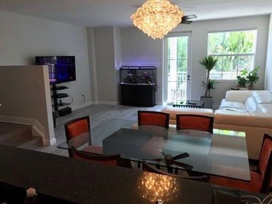 Beautiful fully renovated corner unit townhouse. Porcelain hardwood floors, new chandelier, enormous refrigerator, stainless steel appliances, jacuzzi tub, walk in frameless shower, 4 parking spaces (2 in garage), walking distance to downtown Fort Lauderdale. New window treatments throughout townhouse. Can have two big dogs and/or cats. Basic cable included. Wired alarm system. Washer dryer in unit, dishwasher, lots of custom lighting.