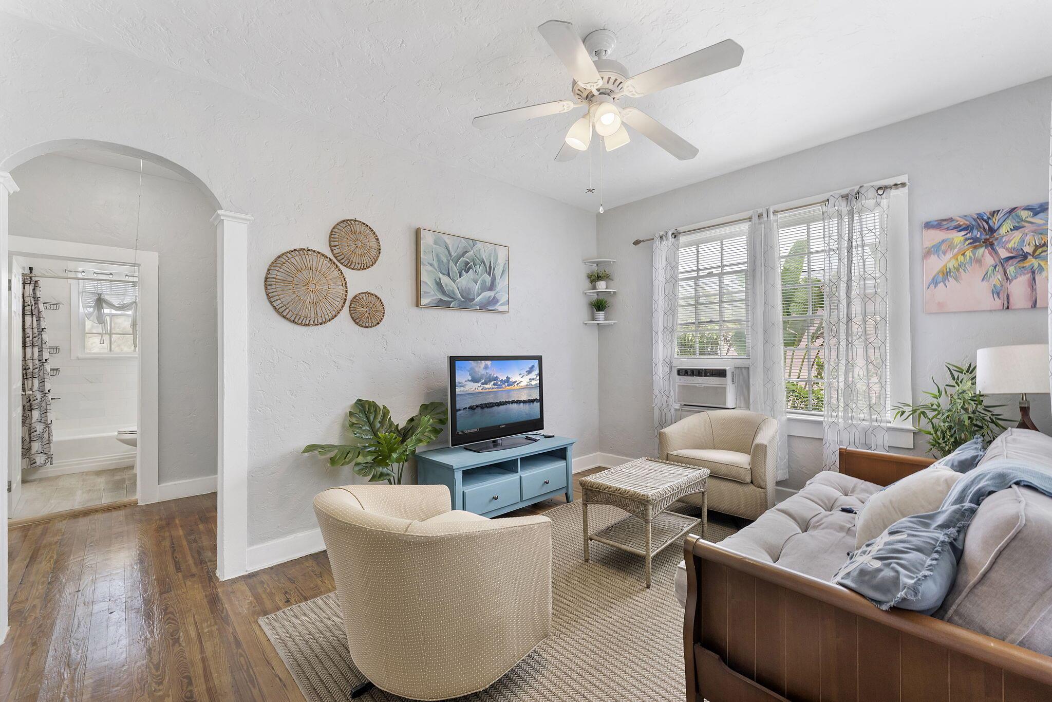 Step right up and discover this charming 2-bedroom, 1-bathroom bungalow nestled in a fantastic Downtown Lakeworth location! With its light blue exterior and inviting curb appeal, this home is ready for you to move right in and start enjoying the Florida lifestyle.Inside, you'll find a cozy and bright living area, perfect for relaxing after a day in the sun. The adorable kitchen features crisp white cabinetry, modern appliances, and a convenient stacked washer and dryer. The home boasts beautiful wood-look flooring throughout the main living spaces, adding warmth and character.
