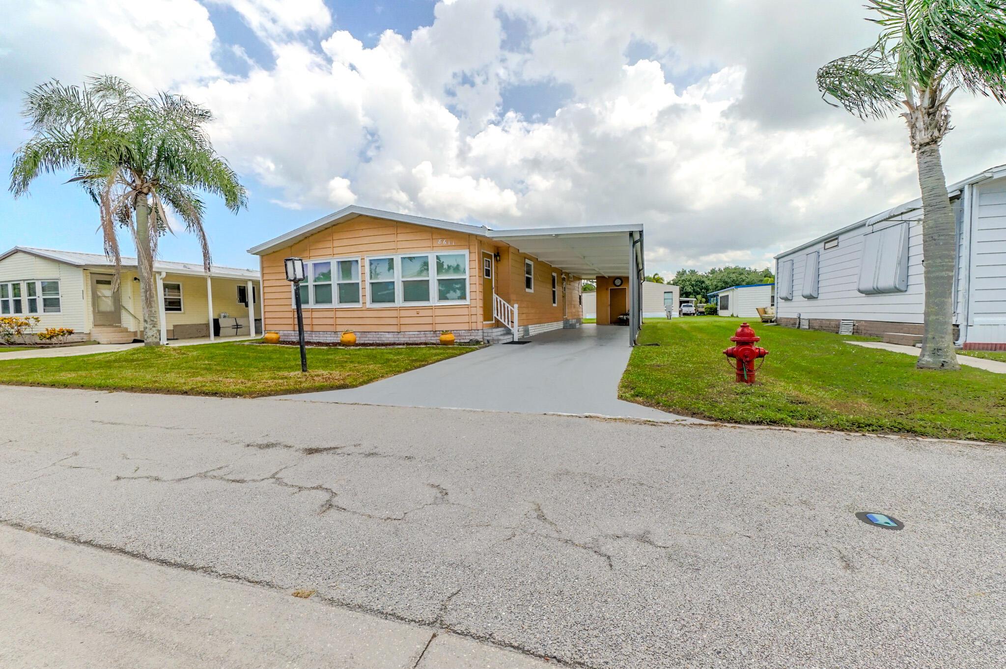 Move in Ready...This 1399 Sq ft home, has been well maintained and features: 3 Spacious bedrooms, 2 full baths, Stainless Steel appliances, Solid wood cabinets, Wood flooring, Washer/Dryer/Utility room, Hurricane rated windows, Carport parking for a couple of cars and Extra Storage. La Buona Vita is a Beautiful 55+ COOP Community, where each owner, owns a share in the community (No Land Lease Fees) Amenities include; A Swimming Pool, Shuffleboard, Clubhouse and Activities as well as RV/Boat storage. The low $197.00 month, HOA fee includes basic cable, Wifi and trash removal. Conveniently located just off US 1, near Restaurants, Shopping, Medical Facilities and the Civic Center and just minutes to our beautiful Hutchinson Island Beaches. Come Check it out!