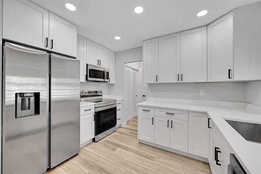 WOW, this home is perfect! New appliances, beautifully kept masterpiece home with attention to details. Accordion shutters on all windows, luxury vinyl plank flooring throughout, quartz countertops, solid wood shaker cabinets, and the list goes on.  Open floor plan! Must see to appreciate.