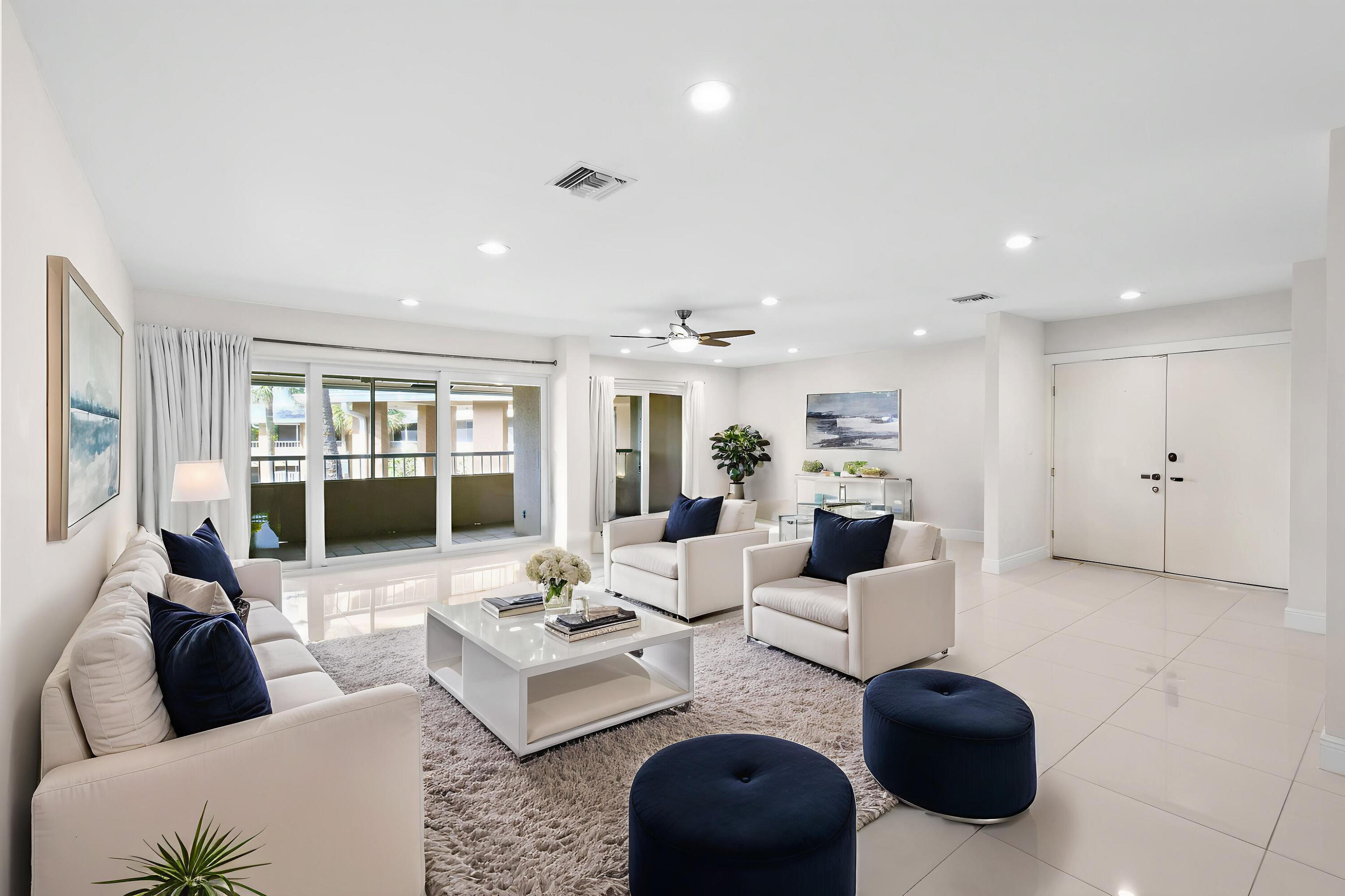 Beautifully renovated 3-bedroom, 3-bath residence offering 2,100 sq. ft. of coastal living on Singer Island. This spacious 2nd-floor unit includes a shared 1-car garage plus a designated outdoor parking space. Completely updated from top to bottom in 2017, the home features hurricane-impact windows and doors, 24''x24'' white ceramic tile throughout, and sliding glass doors in the living room and primary suite that open to a dramatic 12-foot span, filling the home with breezes and natural light. The modern kitchen is appointed with dark maple shaker-style cabinets, white countertops, LG appliances, stacked washer/dryer, and slide-out pantry shelving. The primary bath showcases a double shower for a spa-like retreat. Enjoy two screened porches overlooking the gated pool courtyard, perfect fo