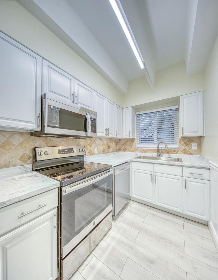 Newly Updated Corner unit with assigned parking unit on the Avenue. All impact windows and doors, big walk in closet, ceramic tile flooring throughout. Updated kitchen with stainless appliance (ref, overhead microwave, dishwasher and range) Laundry on premises.  All new interior paint, led interior lighting etc. Come make this your home.