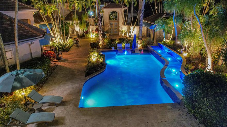 Spectacular Double Lot Courtyard Estate, Massive Outdoor Resort Style Living and Patio space with Resort Style Pool and Spa and Gazebo. Separate Guest House, Luxurious Master Suite on the first floor, gorgeous master bathroom, soaring ceilings throughout the main family room, kitchen, living room, gorgeous real fireplace in the living room overlooking the dining room with natural light all over, custom wall unit with electric fireplace in the family room with 80'' TV and surround sound, all new 36'' marble floors throughout. Full suite above garage, full gym and half bath 2nd level, Guest House 1BR/1BAAbsolute showplace! Must see to appreciate! Please see Club Amenities, Fees and Dues in document section.