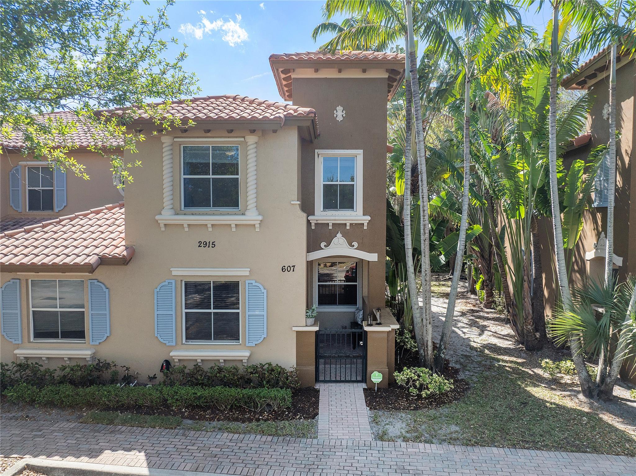 Welcome to your Mediterranean-inspired corner townhome in a gated community, the largest floorplan offered at exceptional value. Gated entrance leads to a charming courtyard opening into a well-cared-for home Main level features open layout, tile flooring, brand-new stainless steel appliances, Upstairs, spacious bedrooms, primary suite with en-suite bath & walk-in closet. Enjoy views of the walking trails with a first floor open patio & upstairs balcony, Recessed lighting upgrades, separate laundry room with a sink, 2 assigned parking spaces, Community offers a pool, playground, and walking trails, Low HOA fee covers building exterior & roof replacement. Near Turnpike, major shopping centers, airport, vibrant downtown WPB. Option to rent immediately for income generation.