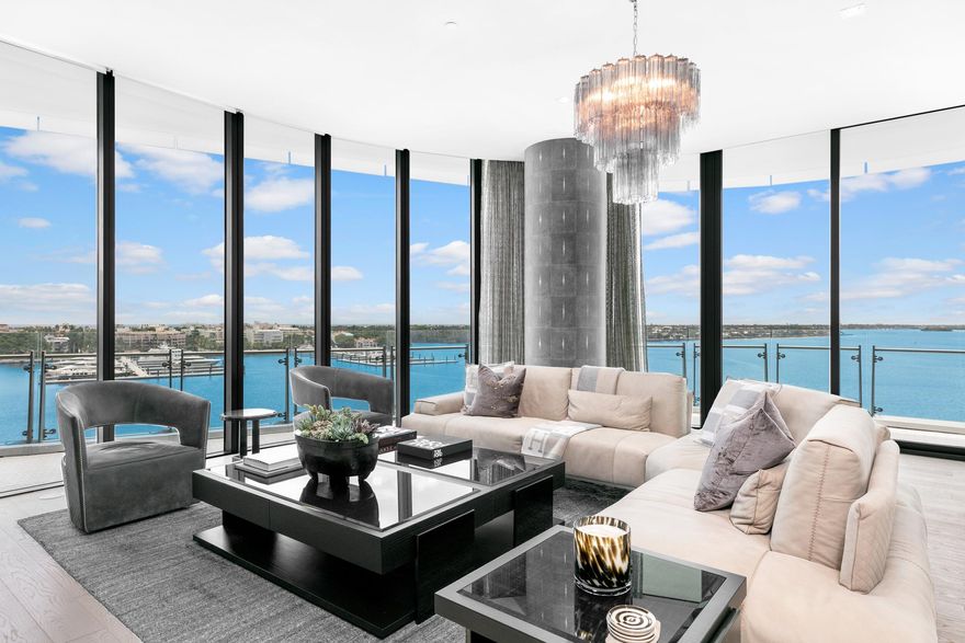 Gorgeous waterfront condominium with custom design by renowned Alissa Sutton Interiors. East, south, and west exposure highlight commanding Intracoastal, Palm Beach Marina, and city views. Featuring 4 bedrooms plus library, five and a half baths, and fantastic wraparound balcony. Dramatic private elevator vestibule leads into grand condominium with rich, contemporary interiors. Stunning finishes throughout with marble wall treatments in select rooms, marble baths, hardwood and marble flooring, and custom designed 400 bottle wine cellar that double as a functional piece of art. Oversized entertaining areas with great room and formal dining room. Gourmet top-of-the-line kitchen opens to breakfast area and family room. Expansive primary suite with dual baths and walk-in closets.