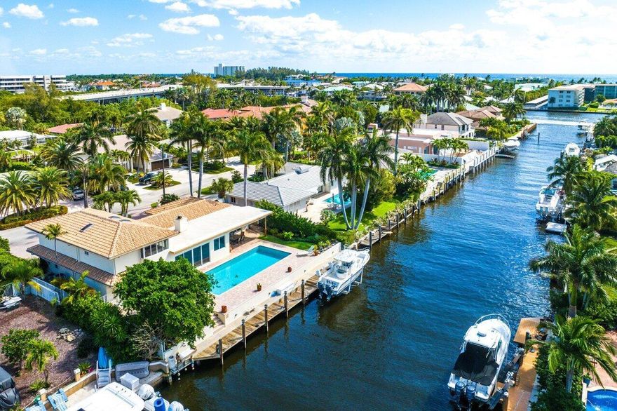 Welcome to your tropical waterfront paradise with something for everyone. Fish or boat your day away from this fabulous waterfront home with 90' of seawall and a 10K+ pound lift. Enjoy your huge 40ft+ heated lap pool year round with its southern exposure offered all day or just watch marine life from your private tropical backyard to the privacy of your living room. A wide-open floor plan that is ideal for entertaining with modern stone flooring, impact windows and wood burning fireplace. Huge master suite upstairs with his & her closets/vanities, Jacuzzi tub and dual shower- separate sleeping quarters with separate office. Enjoy all the local shops & restaurants that Delray Beach has to offer. Only a mile to the beach & 5 minute drive to Delray's famed Atlantic Avenue. This home is fun..