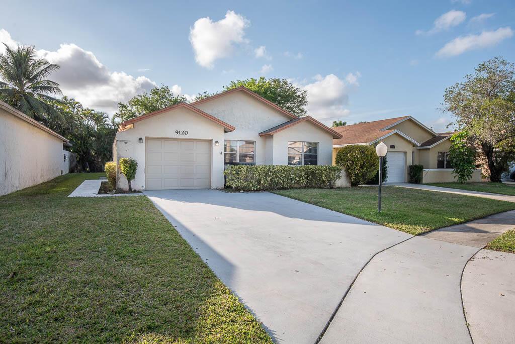 MOVE-IN READY! This beautifully updated 3-bedroom, 2-bath single-family home in central Boca offers modern upgrades and a bright, open feel. Newer kitchen features granite countertops, while oversized marble-like tile flows through the living areas, complemented by hardwood floors in the bedrooms. Enjoy the natural light from two skylights in the living area. Freshly painted inside and out, this home boasts smooth ceilings, elegant crown molding, and a light, airy color palette. Spacious rooms provide comfort, and the bonus covered, glass-enclosed patio with tile adds extra living space. The newly landscaped yard is perfect for outdoor enjoyment. Located in a community with a pool, this pet-friendly home also includes basic cable and lawn maintenance.