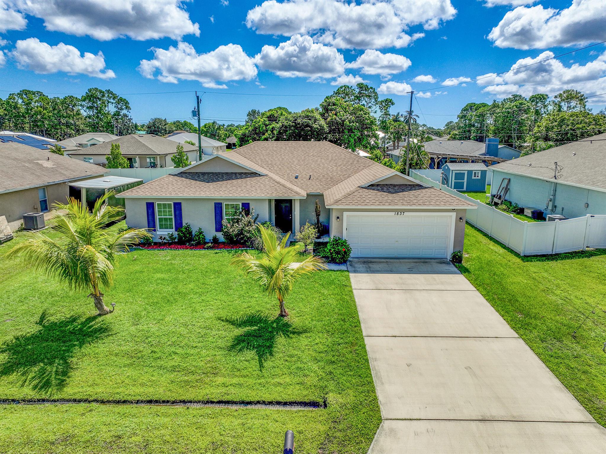 Better-than-new 4-bedroom, 2-bath home in desirable Port St. Lucie! This immaculate home shows like a model, offering an open floor plan with split bedrooms for added privacy. The spacious kitchen features stainless steel appliances, a pantry, and ample counter space for cooking and entertaining. Enjoy the convenience of a dedicated laundry room. Situated on an enormous lot with room for a pool, this property boasts a huge screened-in patio--perfect for outdoor gatherings. The yard is lined with fruit trees, adding to its charm. Plus, the long driveway provides plenty of parking for additional vehicles. No HOA and an 8-foot fence is allowed--giving you more freedom and privacy. Located just minutes from Tradition Downtown, I-95, PGA Golf, shopping, restaurants, and Oak Hammock Park,