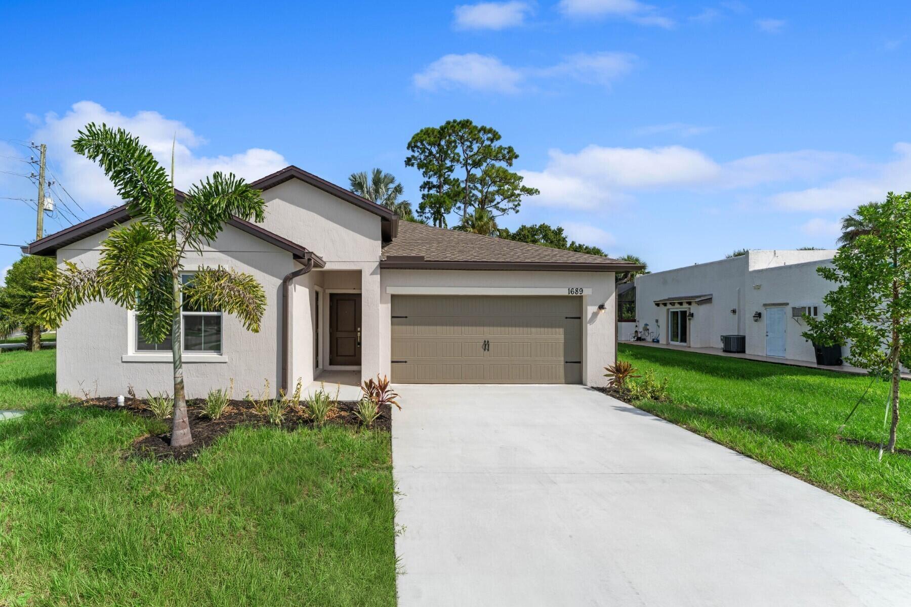 Loft-inspired design meets modern comfort in this spacious Passionflower II, perfectly positioned on a large corner lot in the heart of Port St. Lucie. Built with high-impact windows for abundant natural light and storm protection, this home also includes an upgraded appliance package and a built-in home technology suite as standard, making it move-in ready and future-focused.The layout is designed for both everyday living and entertaining, featuring an Extra Suite Plus that offers privacy and flexibility for guests, in-laws, or extended stays. Vaulted ceilings in the great room and dining area create an airy, open atmosphere, while the kitchen serves as the true centerpiece of the home with a central island, modern pendant lighting, and floating shelves that add character and