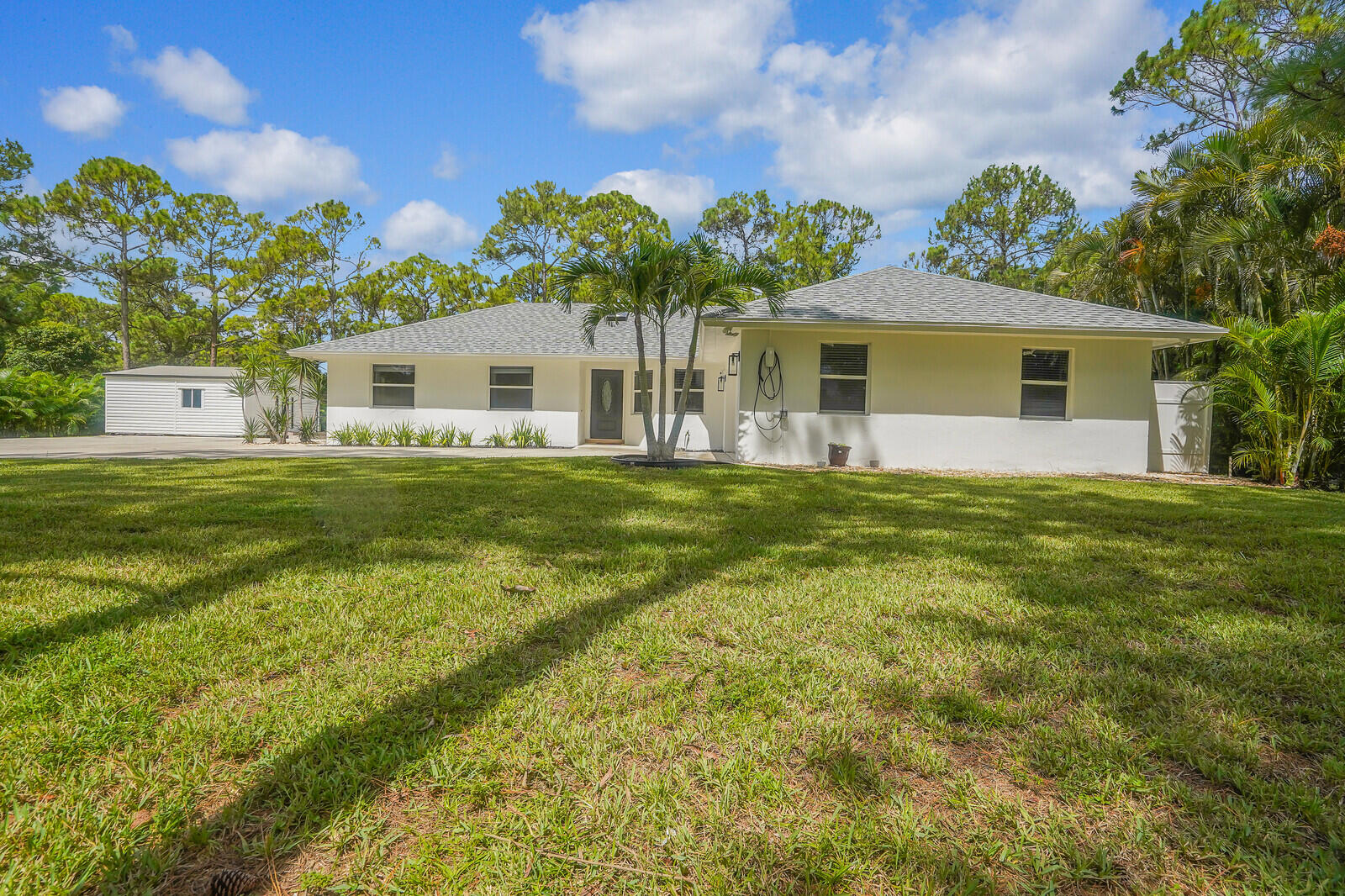 Beautifully newly remodeled home with 3 bedrooms, a den, 2 bathrooms with extra large air conditioned storage building. This home comes with an EV charging station by the garage. The extra large patio runs the length of the rear of the house. The lot is 1.25 acres. Roof, air conditioning, appliances, hurricane impact windows and glass doors new as of 3 years ago. Rent includes, yard care, water treatment and pest control.