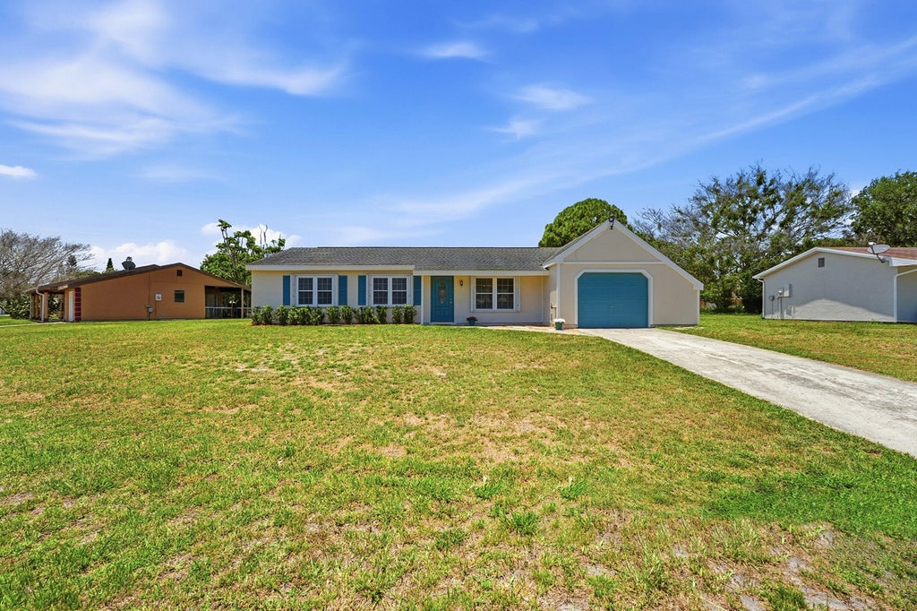 Photo of 450 SW Kentwood Road, Port Saint Lucie, FL 34953 (MLS # B26032908)