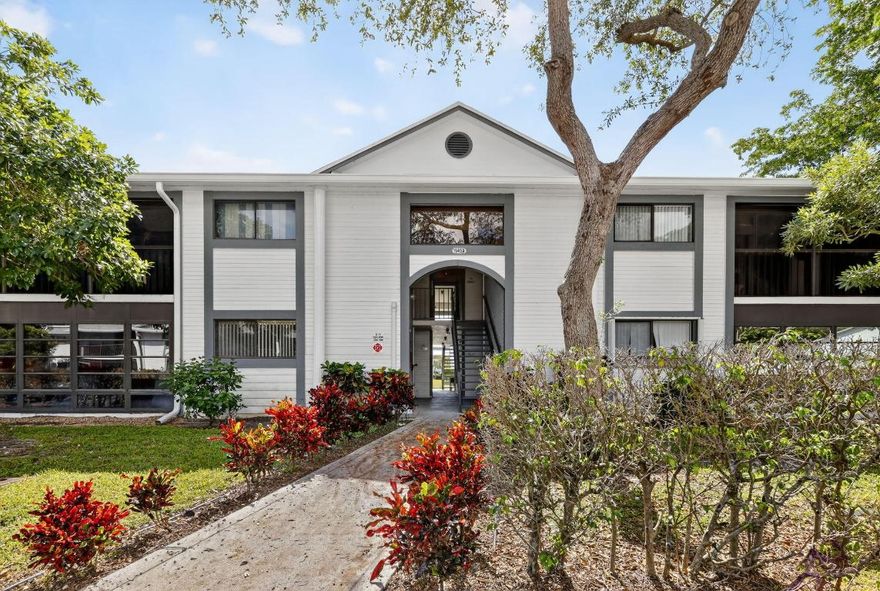 Immaculate, move-in ready 2-bed, 2-bath condo (approx. 1,000 sq ft) situated in the vibrant 55+ community of Lakes of Delray. Vaulted cathedral ceilings in the living area create an airy ambiance, while brand-new porcelain wood-plank tile floors provide contemporary elegance throughout. The kitchen boasts granite countertops and appliances just 18 months old. Both the master and living room open to a carpeted Florida room, perfect for relaxing or entertaining. Bathrooms feature new vanities and updated lighting; ceiling fans added for comfort. Your HOA covers 200+ Xfinity channels and grants access to three pools, a fitness center, shuffleboard, bingo nights, social clubs, and more—social living at its best. Gated and centrally located in Delray Beach, this gem won't last long!