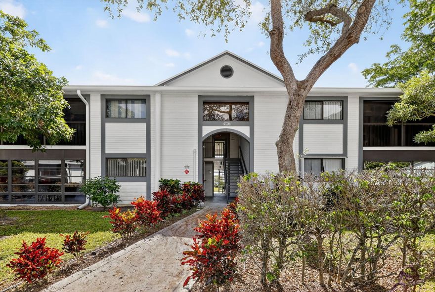 Immaculate, move-in ready 2-bed, 2-bath condo (approx. 1,000 sq ft) situated in the vibrant 55+ community of Lakes of Delray. Vaulted cathedral ceilings in the living area create an airy ambiance, while brand-new porcelain wood-plank tile floors provide contemporary elegance throughout. The kitchen boasts granite countertops and appliances just 18 months old. Both the master and living room open to a carpeted Florida room, perfect for relaxing or entertaining. Bathrooms feature new vanities and updated lighting; ceiling fans added for comfort. Your HOA covers 200+ Xfinity channels and grants access to three pools, a fitness center, shuffleboard, bingo nights, social clubs, and more--social living at its best. Gated and centrally located in Delray Beach, this gem won't last long!