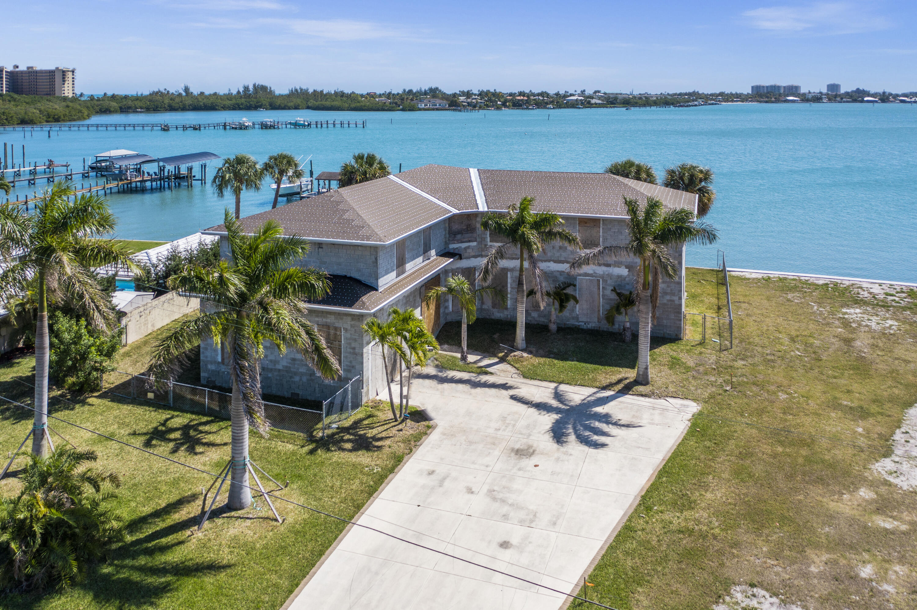 Bring your contractor to finish this fabulous 4 bedroom 4.5 bath deep waterfront home. (water depth is approximately 4 foot at end of current dock structure and approximately 9 foot if extended out similar to neighboring docks.Solid concrete block construction with dried in roof and elevator shaft in place.4,746 sq feet of living area. 6,530 sq ft total.2 large master bedroom suites on the first and second floors.71 ft covered porches on both first and second floor with magnificent wide river views.Owner will finance with $1.1 million down. All situated on .3 acre lot with 109 feet on the water.See floor plans and elevations under documents tab