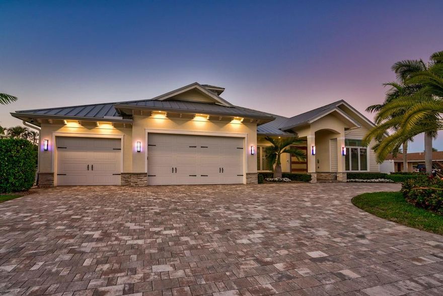 Rarely available! Stunning single story CBS modern estate home on 100' of waterfront.  One of the best ''NO HOA'' streets in PBG, with wide, deep water canal.  No fixed bridges and easy ocean access via Jupiter and Lake Worth inlets.  This newer premier estate home has 5 bedroom, 5.1 bath plus office, 3 car garage, impact glass and all the amenities of the South Florida waterfront lifestyle.  Plenty of parking in this brick pavered, horse shoe driveway.  Walk through this Mahogany door into a spectacular foyer with wood tray ceiling and salt water fish tank.  Open floor plan boosts kitchen with large island, living room and den.  Master bedroom plus 3 additional en suite bedrooms plus office in the main house and separate 1/1 guest house.  One room currently being used as a media room.