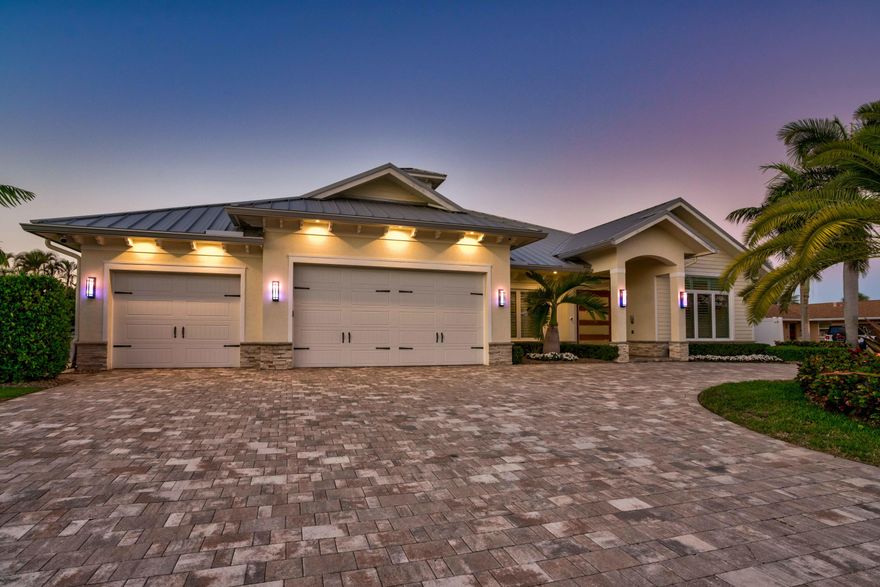 Rarely available! Stunning single story CBS modern estate home on 100' of waterfront.  One of the best ''NO HOA'' streets in PBG, with wide, deep water canal.  No fixed bridges and easy ocean access via Jupiter and Lake Worth inlets.  This newer premier estate home has 5 bedroom, 5.1 bath plus office, 3 car garage, impact glass and all the amenities of the South Florida waterfront lifestyle.  

Plenty of parking in this brick pavered, horse shoe driveway.  Walk through this Mahogany door into a spectacular foyer with wood tray ceiling and salt water fish tank.  Open floor plan boosts kitchen with large island, living room and den.  Master bedroom plus 3 additional en suite bedrooms plus office in the main house and separate 1/1 guest house.  One room currently being used as a media room.