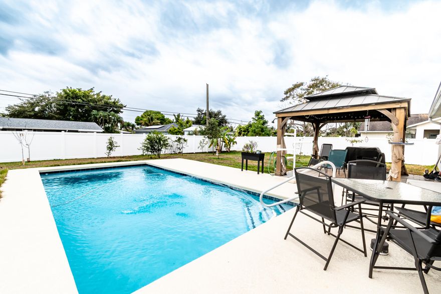 MOVE IN READY POOL HOME! Why wait to build? Enjoy peace of mind in this 2024 Holiday Builders home with a pool, featuring 3 bedrooms, 2 bathrooms, and a 2-car garage with attractive stone accents on the front exterior. The kitchen boasts a stylish backsplash and an open flow and functional layout. Step outside to a 12x24 pool completed in 2025, with a sitting ledge, app-controlled automatic cleaning system, programmed control box, and pool equipment including a pool vacuum. A white vinyl fence (2025) adds privacy. Dont miss your chance to get into a newer home with a pool, this doesn't happen often. Great Location to amenities, restaurants, and the Port District.