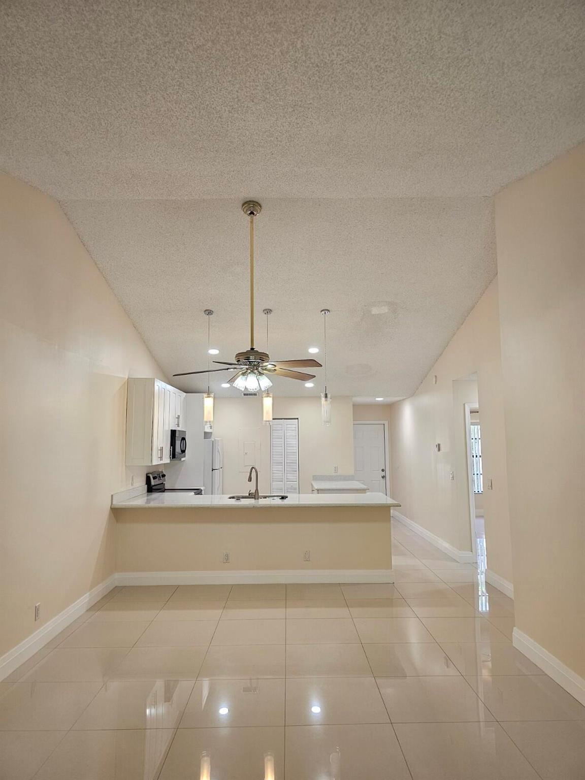 Rarely available 3/2 villa in centrally located fabulous community of Windwood. The villa is renovated, 32'' porcelain tiles all over, custom kitchen layout with wood cabinets and quartz countertops, updated bathrooms, newer blinds,newer A/C, led lighting, full size washer & dryer inside the unit, freshly painted. Many amenities of the community includes 24 hour security services, 24 hour manned gate , 2 swimming pools, 3 tennis courts, 2 clubhouses for social events, basketball court, 1 mile jogging path for you to enjoy the picturesque 20 acres lake with swans, ducks and natural life. Two assigned parking spaces. Ready to move in immediately in the center of east Boca. Minutes to FAU, LYNN, MIZNER PARK and the beautiful BOCA BEACHES.