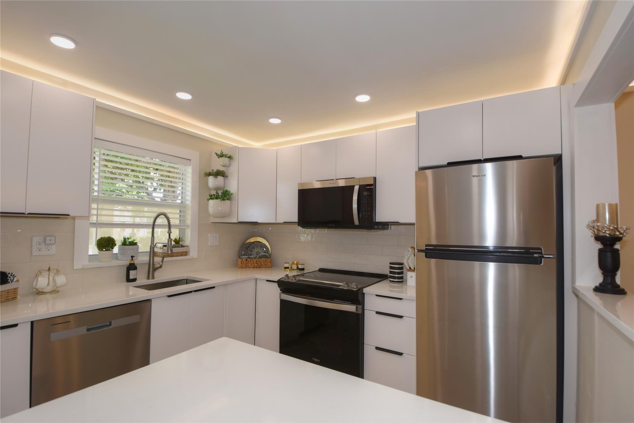 Light, Bright & Airy NEWLY RENOVATED FIRST FLOOR 1 Bedroom 1.5 bath 55+ Community in Sunrise Lakes Phase 3. White modern cabinets, quartz countertops, SS appliances. Laminate flooring (sand color) throughout with white tile in bathrooms. Large bedroom with spacious walk-in closet. Laundry facility on each floor. Extra locker storage. COMPLIMENTARY GOLF COURSE, many pools to choose from, indoor & outdoor. Various activities to choose from, you will not be bored! This community is very well maintained, and the roof was just recently replaced.