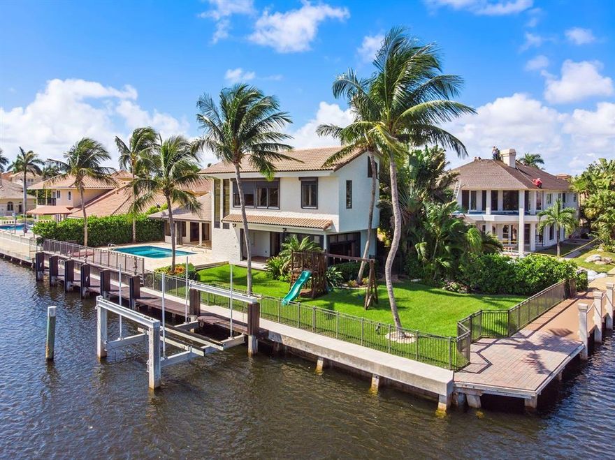 An extremely rare oversized point lot in Delray Beach is now available. Encompassing over 12,000 total square feet of land, 198 feet of water-frontage with 133 feet on the intracoastal and 65 feet on the side canal, this point lot has sweeping views of the water from every direction. You can move right into this traditional ''Tommy Bahama'' styled home or update to your heart's desire. Interior features include 4 bedrooms, office / den, wide open great room with exposed wood beams, fireplace, master bedroom downstairs and chefs' kitchen with island. Outside, you find a huge pool, spa giant grassy side yard with room to run. Point lots like this give the owner the ability to keep their boat away from the wake activity on the side canal while maintaining the amazing intracoastal view.