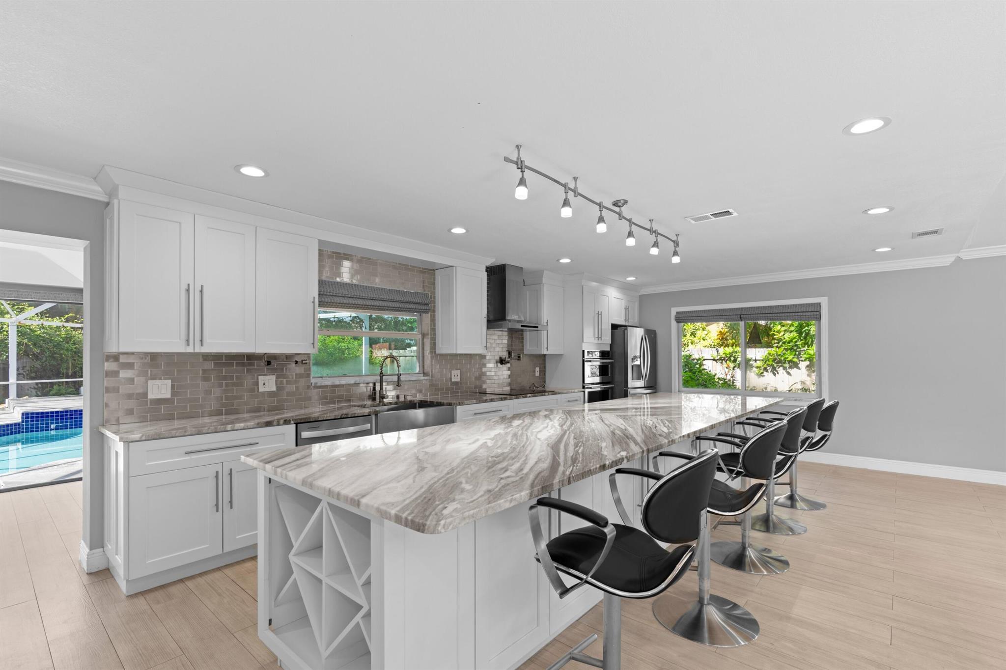 Located on a quiet cul-de-sac in one of Wellington's most desirable neighborhoods, this renovated 4-bedroom, 2.5-bath home sits on an oversized corner lot. The open-concept layout features a chef's kitchen with an oversized island, modern finishes, and stainless steel appliances--ideal for both everyday living and entertaining.The spacious primary suite includes a walk-in closet and a well-appointed en-suite with dual vanities. Enjoy complete privacy in the backyard with a covered patio and sparkling pool. Additional features include a sunroom, ample closet space throughout, a two-car garage, and generous driveway parking. A rare opportunity to own a move-in ready home in a premier Wellington location.
