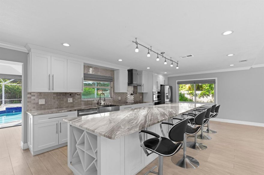 Located on a quiet cul-de-sac in one of Wellington's most desirable neighborhoods, this renovated 4-bedroom, 2.5-bath home sits on an oversized corner lot. The open-concept layout features a chef's kitchen with an oversized island, modern finishes, and stainless steel appliances--ideal for both everyday living and entertaining.The spacious primary suite includes a walk-in closet and a well-appointed en-suite with dual vanities. Enjoy complete privacy in the backyard with a covered patio and sparkling pool. Additional features include a sunroom, ample closet space throughout, a two-car garage, and generous driveway parking. A rare opportunity to own a move-in ready home in a premier Wellington location.