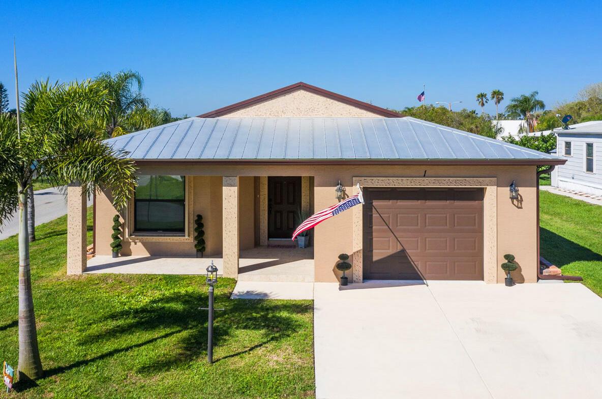 Discover true Florida living in the 2-bedroom, 2-bath Carlton model featuring a spacious layout, soaring vaulted ceilings, a covered front porch, and attached garage. Built with solid concrete block, this home boasts quartz counters, stainless steel appliances, and elegant finishes. The split-bedroom design ensures privacy while the open living area flows perfectly for entertaining. This move-in-ready home was built with 3/16th true plywood roof sheathing, hurricane tie straps, R-30 insulation, and hip roof designs ensuring big insurance premium discounts. Our homes also come equipped with energy efficient appliances, keypad door locks, a continuous quartz kitchen backsplash, plus durable and stylish 36-inch wood cabinets with a built-in pantry.
