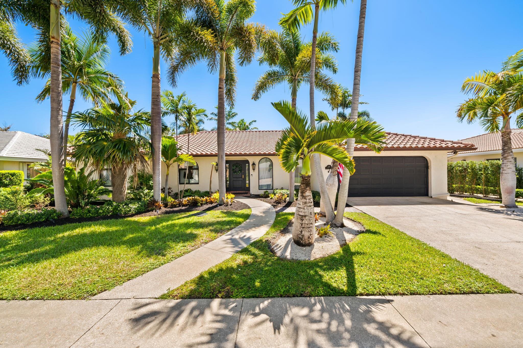 Welcome to Casita de Palmas, a beautiful Mediterranean-style home in sought after Carriage Hill. This one level executive residence offers elegant details-arched doorways,columns custom bookshelves, and a gourmet kitchen with oversized island. Walls of impact sliders seamlessly connect the den, living room, and primary suite to the outdoors for effortless indoor-outdoor living. Enjoy a huge screened lanai with summer kitchen, hot tub and dining for 10 overlooking the sparkling pool and lush tropical gardens equipped with a 20 ft privacy hedge and open-air shower. Flexible floor plan with the den and a 4th BR/library-perfect for home office. New full house generator, low HOA, no gate and top-rated schools. Close to beach and shopping and all that Boca living has to offer.