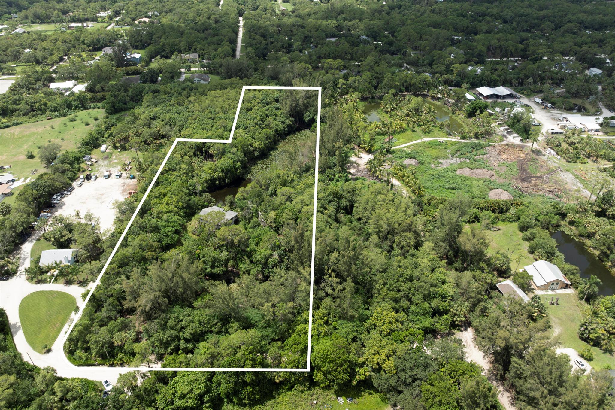 Exceptional 6.09-Acre Agricultural Residential Property in Jupiter Farms - Prime LocationDiscover the perfect blend of serenity and convenience with this rare 6.09-acre dry lot in highly sought-after Jupiter Farms. Nestled just moments from Riverbend Park and a short drive to shops, dining, I-95, and the Florida Turnpike, this property offers the ideal balance of peaceful seclusion and easy access. With two picturesque ponds and a tranquil, natural landscape, this property is a true sanctuary--perfect for those seeking space, privacy with endless potential. Zoned Agricultural Residential, it presents a unique opportunity to build your custom estate home, equestrian stables, or even a private corporate retreat. Enjoy wide open skies, mature trees, and the sounds of nature all