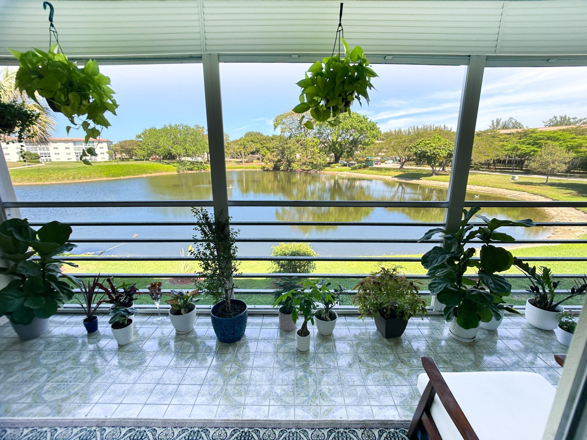 BACK ON THE MARKET WITH NEW KITCHEN WATERFALL COUNTERTOP AND BACKSPLASH, NEW FAUCET AND SINK, DROP CEILING WITH RECESSED LIGHTS. This 2 Bed/2 Bath Unit Offers a PANORAMIC LIGHTED WATER FOUNTAIN & GOLF COURSE VIEWS! DINING AREA FEATURES A MODERN FLOOR-TO-CEILING WOOD SLAT ACCENT WALL THAT ADDS WARMTH AND STYLE TO THE SPACE. Includes WINDOW TREATMENT, NEW LIGHTING THROUGHOUT THE UNIT; UNFURNISHED. WYNMOOR, a Premier 55+ Community, offers exceptional range of amenities, including an 18-holes Golf Course, Movie Theater, Fitness Center, Pickleball, Tennis, Racquet Ball, Shuffle Board, SPA/Hot Tub, Main POOL - Walking Wave, and more. Courtesy Bus. Golf Membership is available for just $650 a year. Residents enjoy a vibrant lifestyle with endless opportunities for relaxation and recreation.