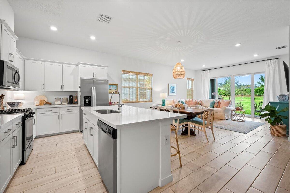 Enjoy lakeside community living with amazing pool, tennis courts, farmer's market, canoeing and more! Newer construction with beautiful open kitchen with family room overlooking the landscape. Desirable split floorplan with primary bedroom with two walk in closets in the rear and 2nd and 3rd bedrooms in the front. Alarm system, and garage with electric openers. Just 15 minutes from Wellington's International Equestrian Center. Easy access to I-95 and Southern Blvd.