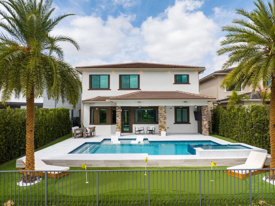 Exquisite Emerald model in prestigious Cascata at MiraLago. 5-bedroom, 4-bath residence showcases soaring ceilings, elegant open layout, and tranquil lakefront views, with a convenient first-floor bedroom. The gourmet kitchen features upgraded cabinetry, quartz countertops with full backsplash, snack-bar seating, and poolside dining. Refined interiors include crown molding, designer finishes, and Restoration Hardware chandeliers in the formal living and dining rooms. Enjoy a private gas-heated pool and oversized spa framed by crystal white sandblasted marble pavers, turf, and lush landscaping with Sylvester palms plus a personal putting green. Hurricane-impact windows, custom stone fireplace wall, flex storage with sink and cabinetry, and an expansive balcony. A rated schools and amenities