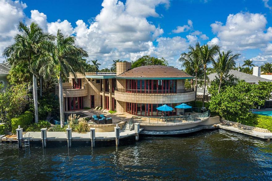 Dos Lunas is a Masterpiece estate directly on the Intracoastal Waterway. This dream home was designed and decorated by owners Derek and Lisa Vander Ploeg and took over 3 years to build. This Frank Lloyd Wright inspired vision has 4 Bedrooms plus Den or Office/7 Bathrooms, beautiful custom kitchen featuring Mahogany Cabinets, state of the art appliances and custom Rainforest marble countertops. The 4300 Sandstone wall tiles featured on the exterior and interior walls in addition to the ''Noce'' travertine (glossy inside and honed outside) all contribute to the indoor-outdoor natural flow. Infinity edge pool, 60' foot dock, whole home Generator, underground 500 gallon propane tank, two fireplaces, The ''two moon'' design is evident in the curvature of the Master Bedroom Suite.