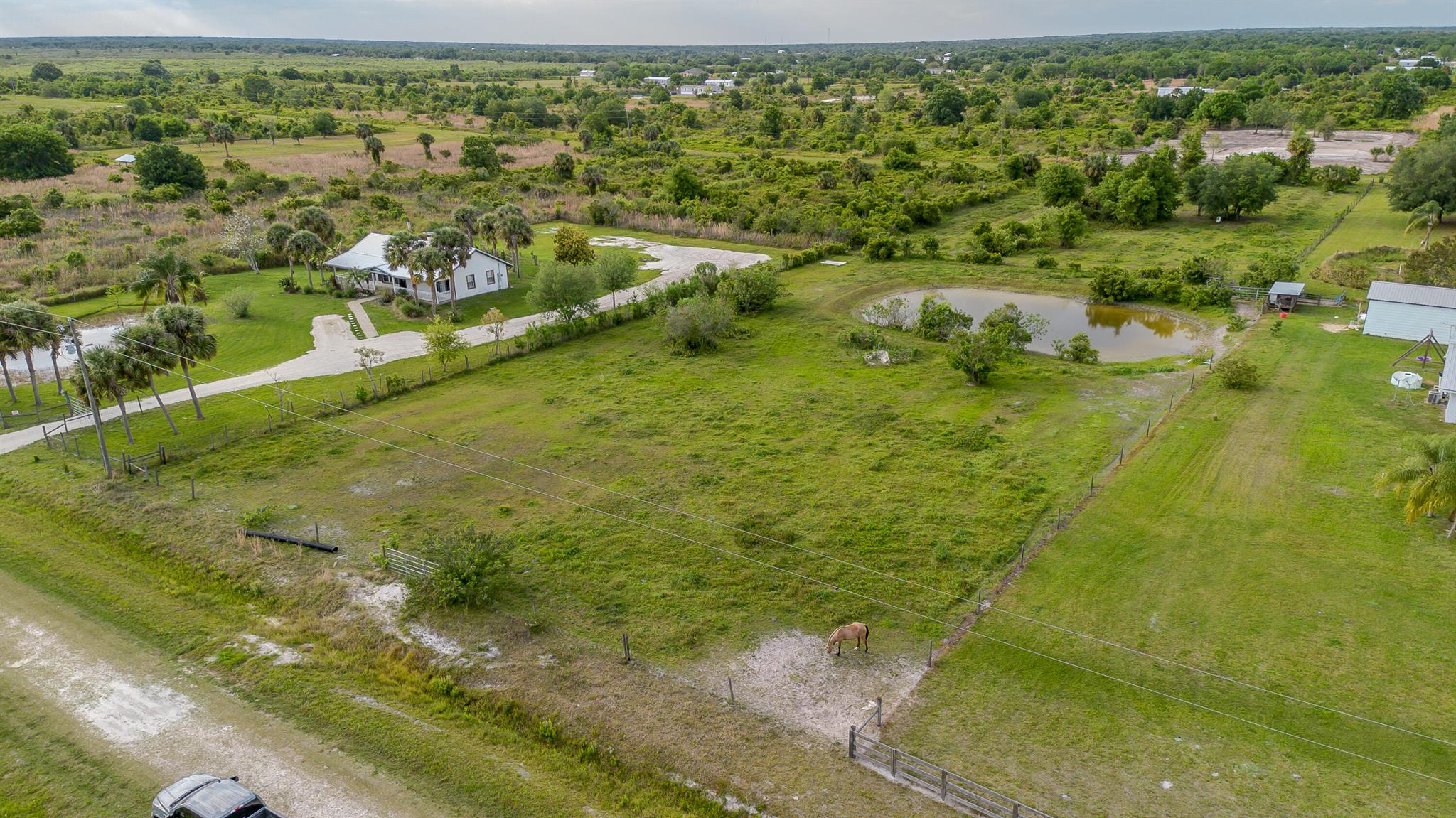 **Vicking** Beautiful cleared lot, Completely fenced with large pond. High and Dry. Power pole in place. Approved for placement of manufactured home or build your dream home with the luxury of no HOA. Located just a few short miles from the Kissimmee State Park.Dimensions are approximate, must measure for exact.