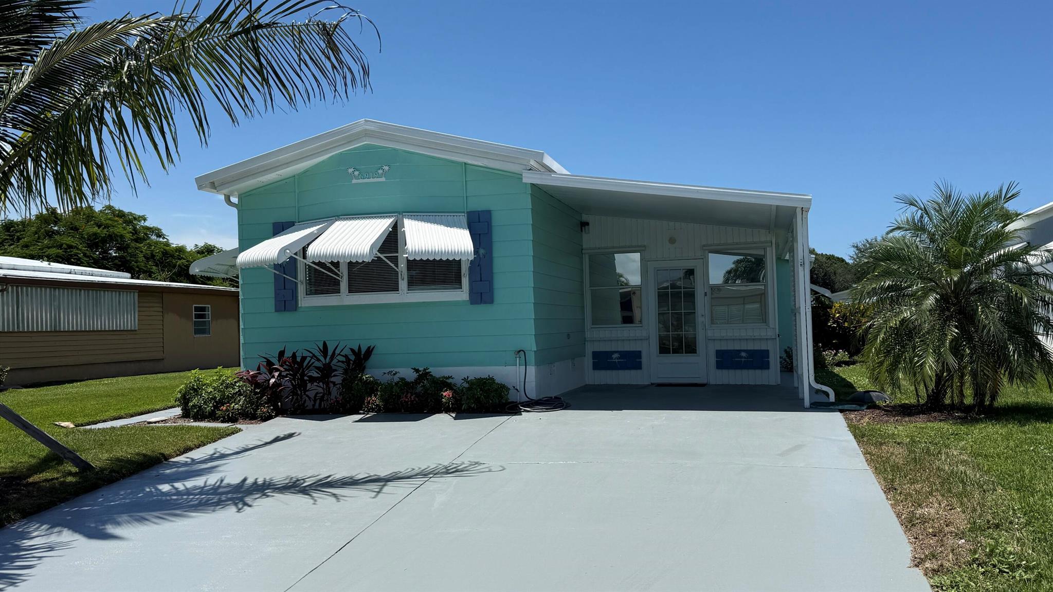 EXTREME MAKEOVER!!! Gorgeous 2 Bedrm/2 Bath Manuf home in Cambridge 55+ community in Hobe Sound. BRING YOUR BOAT/RV. All new vinyl plank flooring thruout over 3/4 inch Ply-wood subfloors. 2X4 16'' on center construction w custom tie downs. New Aluminum roof-over 2012. Electric zoned, well fed, sprinkler system, 2021 A/C. New Shaker Style bright white OPEN kitchen w quartz counters, LED lighting & stainless range, microwave & dishwasher. SPLIT Bedroom Plan. Both Bedrms have ensuite baths. You enter the home into a FL room w custom staircase to Great Room. The 10X32 Bonus/Rec room is on the same level w a pegboard wall, washer/dryer, slop sink & beer frig. Great Curb Appeal!! Cambridge is mins to Ocean Beaches, ICW Boat Ramp & shopping.. YOW OWN THE LAND - ALL PETS WELCOME. Low HOA.