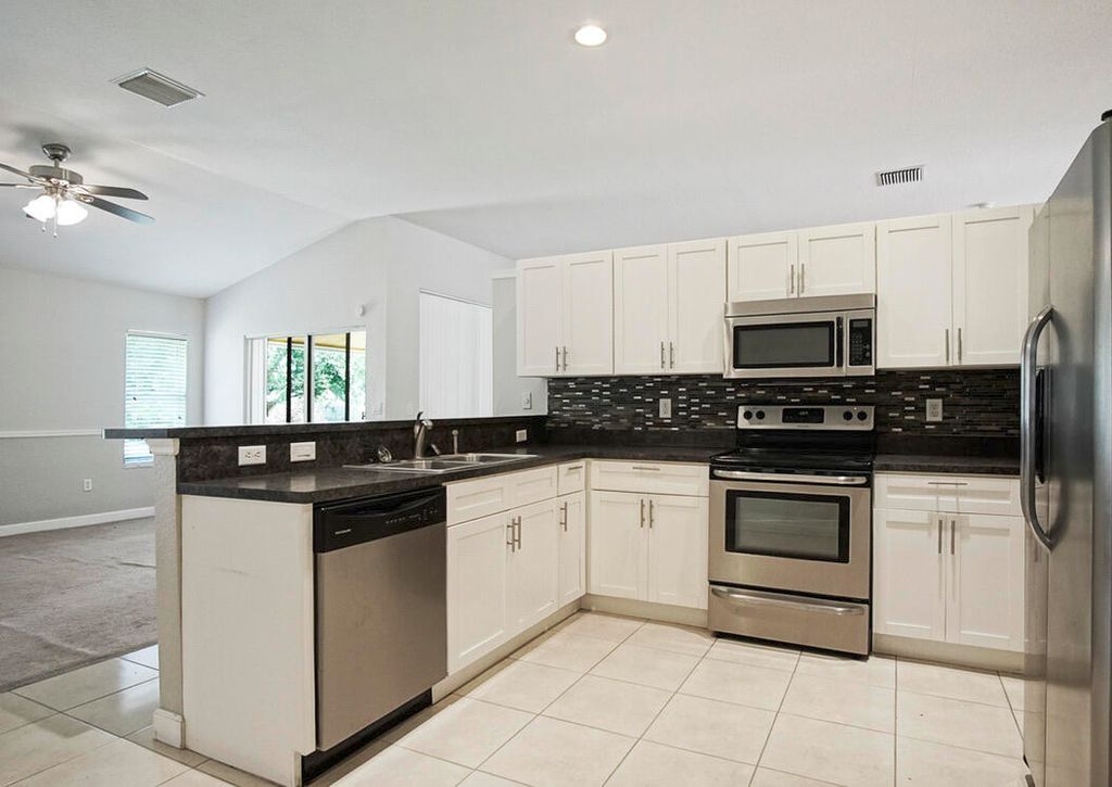 Photo of 1961 SW Delmonico Avenue, Port Saint Lucie, FL 34953 (MLS # B26019433)