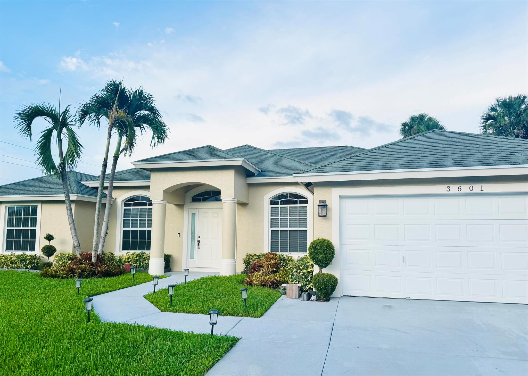 Live in Your Own Private Tropical Paradise - Stunning Custom Home for Rent in Port St. LucieImagine coming home to your lush Florida sanctuary surrounded by towering coconut palms, sweet pineapple plants, and organic mango trees ripe for picking.This beautifully maintained custom-built home offers:Open, airy split floor plan with soaring ceilings - elegant and grandGleaming tile floors throughout - stylish and easy careSpacious bedrooms with abundant natural light - Split -3 areaStep outside into paradise:Luxuriously landscaped luxury gardens maintained by ownerMultiple mature mango and lime treesFragrant jasmine vines, privacy hedges, and tall coconut palms swaying.Pet friendly - your furry family is welcome! Partially Furnished or removable.