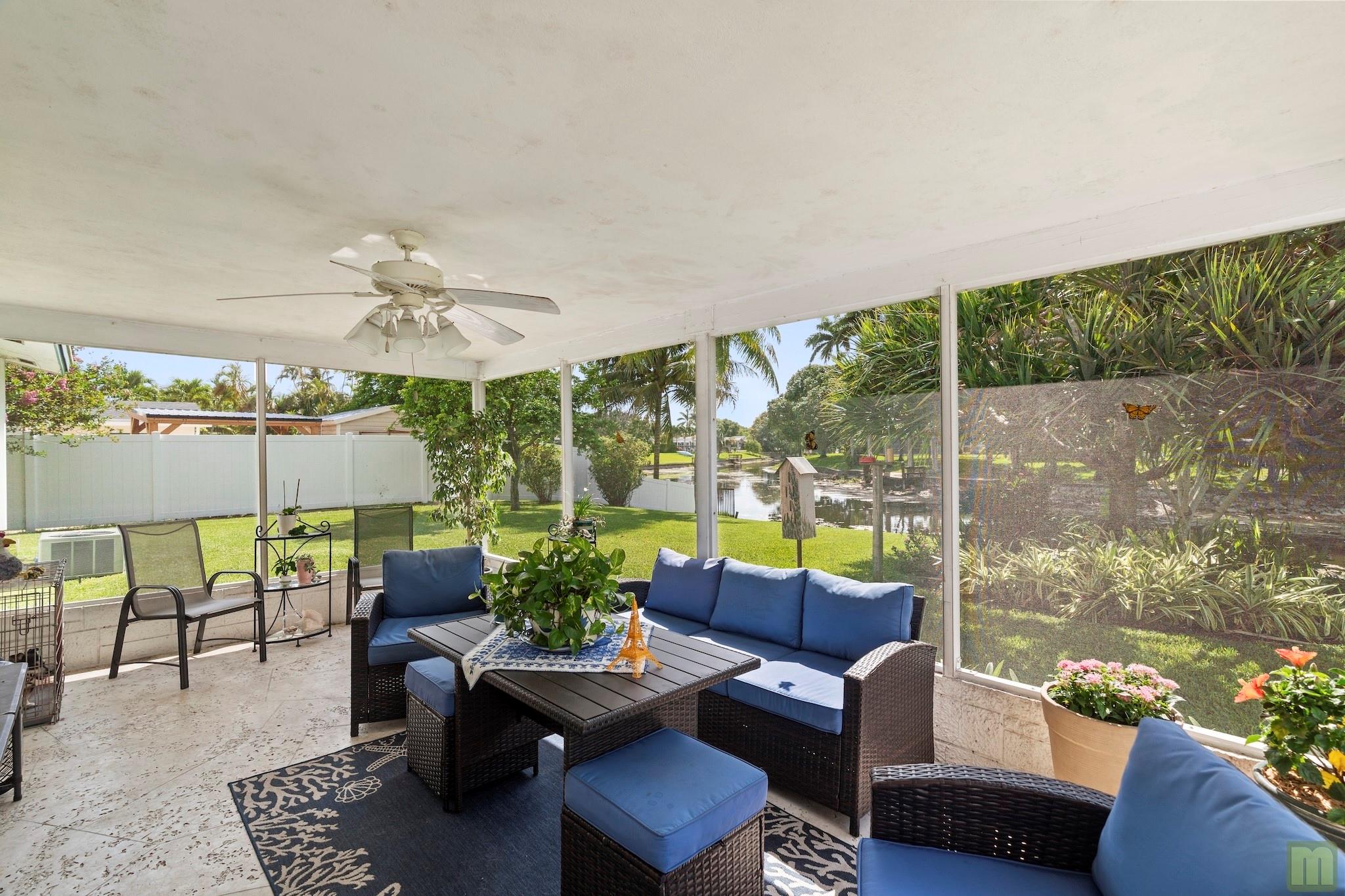 THIS IS THE PRICE REDUCTION YOU'VE BEEN WAITING FOR!! - This lovely 2 bedroom, 1 bath home sits on an over-sized lot overlooking a quiet waterway with plenty of room for a pool. The 1-car carport can easily be converted to a garage or an extra bedroom with the option of turning the carport storage area/workshop into another bathroom! Flat tile roof installed in 2020, Water heater 2024, and AC 2008. full hurricane shutters, updated kitchen with granite countertops and maple cabinetry. Enjoy quiet evenings on a fully-screened patio with an expansive backyard view, dock & 103 feet of waterline. Quiet neighborhood with amazing parks and an elementary school within walking distance and just a short drive to the Coconut Creek Promenade, shopping, banks and just 7 miles to the beach. NO HOA!