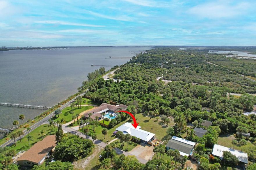 Your Florida Dream Home: Renovated, Water Views, and Direct Water Access! This turnkey, 3-bedroom, 2-bath residence on Indian River Drive has been completely and meticulously renovated, both inside and out, exuding bright and airy coastal-modern charm. Situated on a well-manicured and landscaped lot just over half an acre, the property offers stunning, unobstructed water views of the Intracoastal. The large kitchen is a chef's delight, with modern stainless-steel appliances, white stone countertops, an oversized island for informal dining, a spacious pantry, and a wet bar. The main living areas feature fresh white paint and wood plank-like ceramic tile, while a formal dining room and private den/office provide additional functional spaces. Every inch of the interior has been updated with loving care, including fully renovated bathrooms. The luxurious master suite is privately located and includes its own ensuite and separate backyard access. Located across the street is a separate waterfront parcel on the Indian River, where you can build a private dock for direct water access. The backyard features a new aluminum screened porch with tiled flooring and a tiled back patio (2022), a new/never-used hot tub, and a private outdoor shower with a new enclosure and fixtures (2025). The home is built for peace of mind, with a new metal roof (2018), R-34 blown attic insulation (2018), and all-new plumbing and electrical (2018). Impact windows and doors provide safety and security, and the tankless water heater (2018) provides endless hot water. Other recent upgrades include a new A/C, air handler, and ductwork (2023), a salt-water system installed on the wells, a new septic pump and well (2021), a new drain field (2022), a new exterior stucco and paint (2018), and a brand-new 8-zone irrigation system (2024). This Florida dream home offers the best of coastal living with no HOA, allowing you to bring your boat, cars, and toys with no restrictions. This move-in ready home is a must-see! Easy to show!
To see the complete list of updates and features see the attached public document.