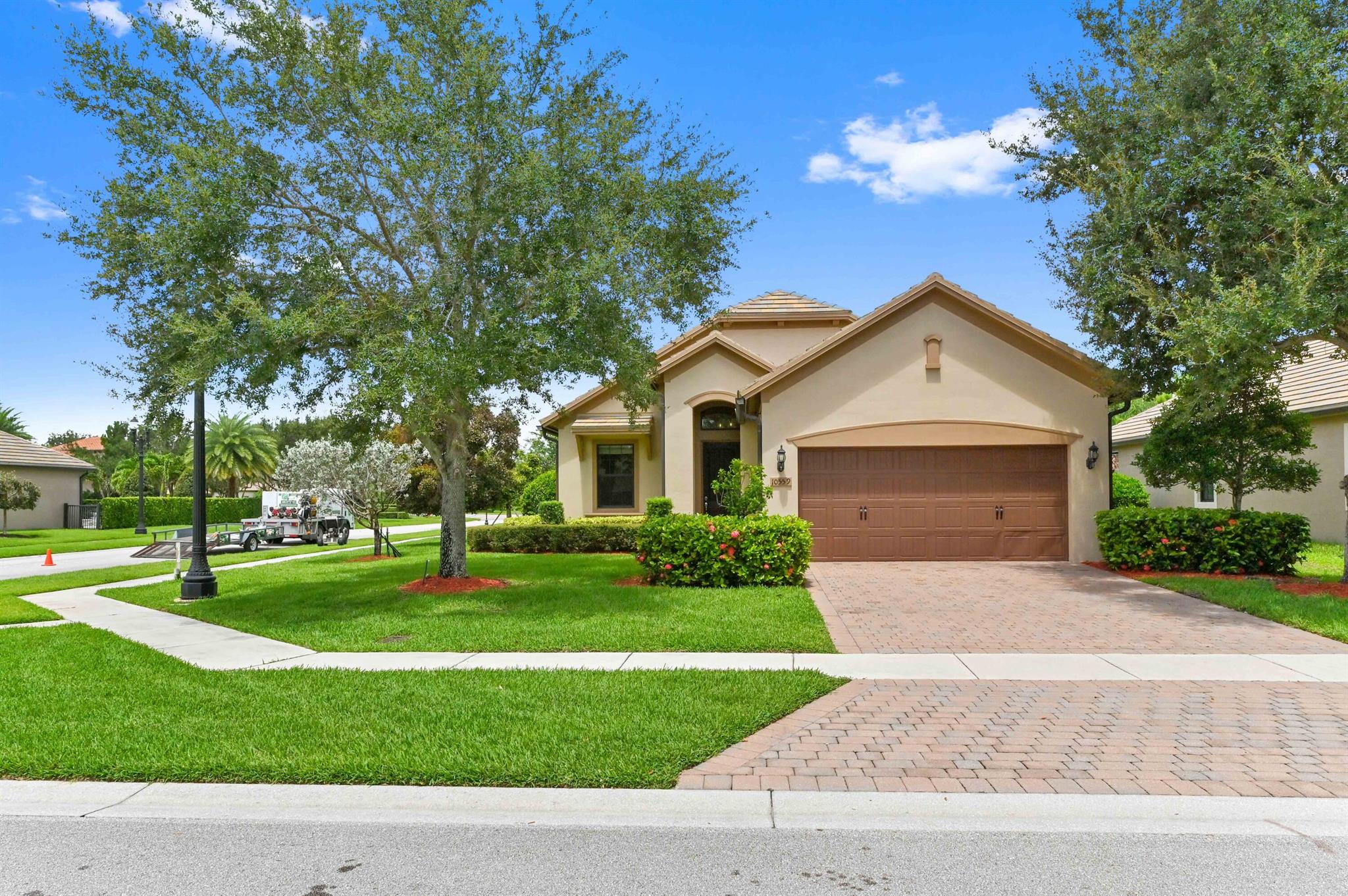 Welcome to this beautifully maintained, light-filled 2-bedroom, 2-bathroom home with a flexible bonus room--perfect for a home office, gym, or den. Located on a large corner lot just steps from the clubhouse and pool, this smart home also features a two-car garage and hurricane impact windows and doors for extra safety and peace of mind.Inside, you'll find quartz countertops, tile flooring throughout, and an upgraded screened-in patio with a large ceiling fan--a great space to relax or entertain. The home is low-maintenance, with front and backyard lawn care covered by the HOA.