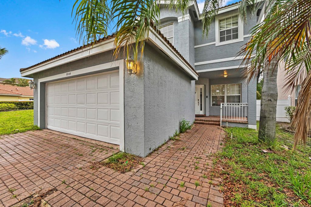 Photo of 5049 Starblaze Drive, Greenacres, FL 33463 (MLS # B26020116)