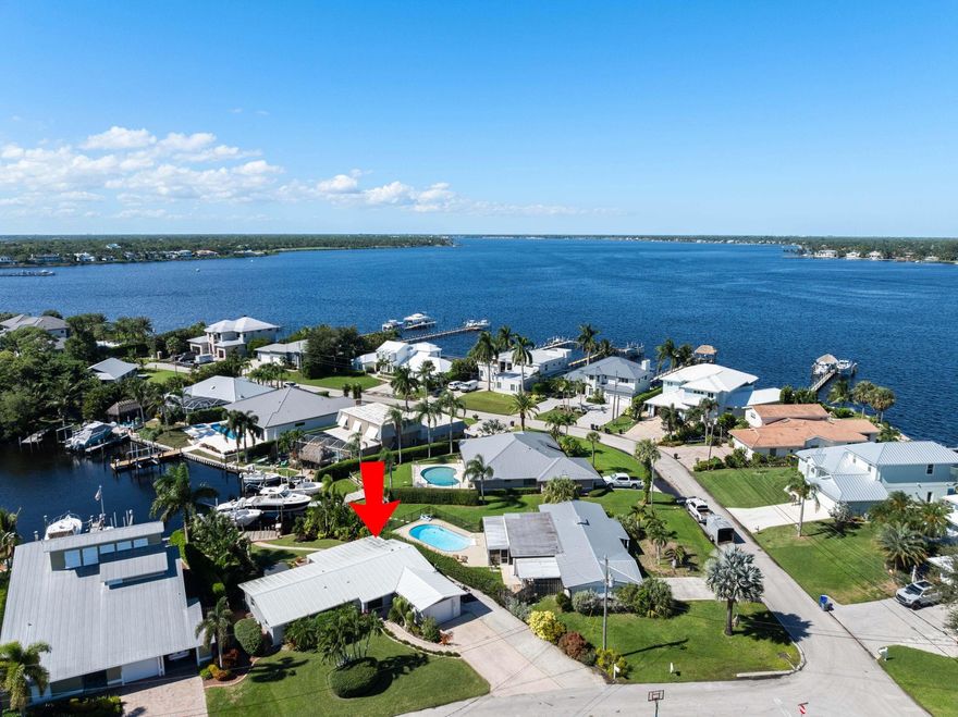 Exceptional ocean access residence featuring a 12,000 lb boat lift and 63 feet of water frontage, perfectly suited for up to a 35 ft vessel. This elegantly updated 3-bedroom, 2-bath home offers comfort and coastal luxury, surrounded by lush tropical landscaping. Enjoy an open, updated layout with GE stainless steel appliances, impact windows throughout, and refined finishes. The expansive backyard offers ample room for a pool, creating the opportunity to design your own private outdoor oasis. Ideally located just minutes to the St. Lucie River, waterfront dining, and the iconic Stuart Sandbar — a dream location for avid boaters. Nestled in a quiet, family-friendly neighborhood with access to top-rated A-schools. A true waterfront gem and an exceptional value in a prime location.