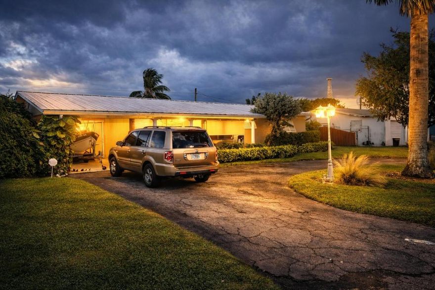 Bring your water toys to boater's paradise. Beautiful home with dock on canal between Lake Clarke Shores and Lake Osbourne. This open floor plan home was updated in 2004-custom tile baths, ceramic tile flooring throughout, and 2018-white kitchen cabinets/black granite, metal roof, electric., impact windows (all but 2), generator. Large formal living room can convert back to 3rd and 4th bedrooms (add 2 walls.) The French doors of great room lead to the covered porch. 2nd door leads to patio. This waterfront oasis is the perfect home for entertaining and has room for a pool! Home boasts security system, speaker system, 4 zone auto sprinklers, carport, fruit trees, shed and ''orchid house for extra storage and plantings. NO HOA and SUPER LOW TAXES!! Convenient to shops,schools,I95