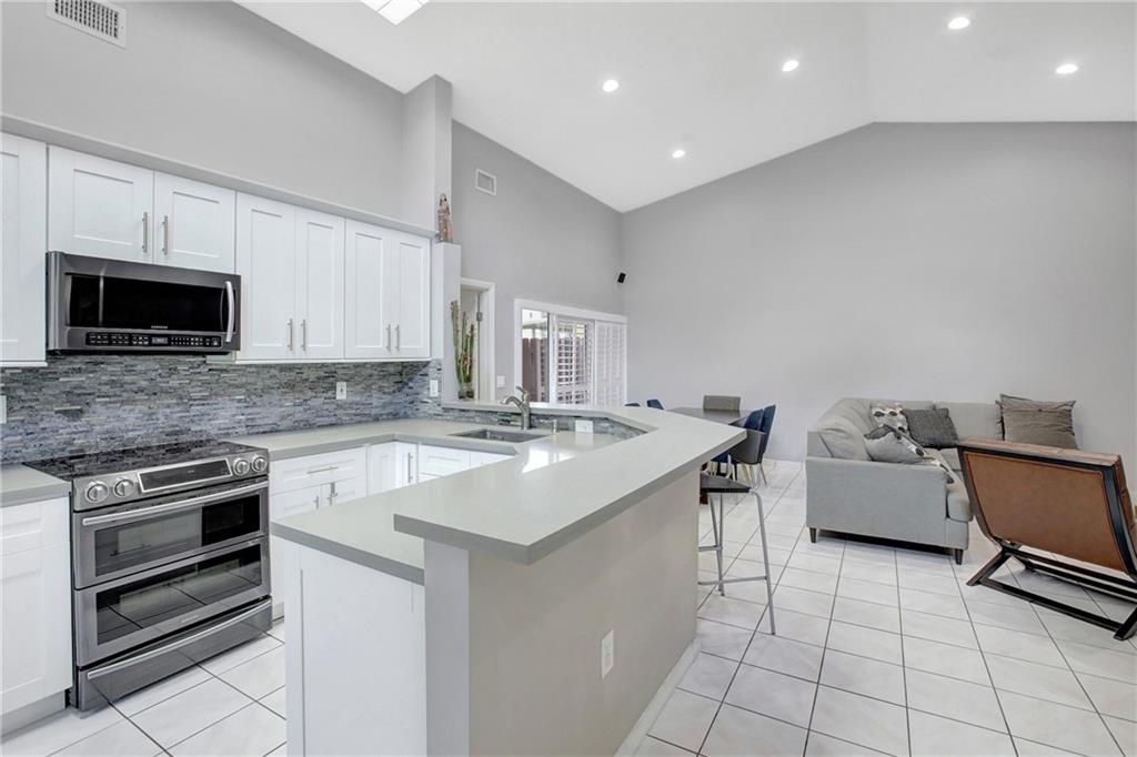 Now available is this charming single family home in Hampton Lakes! The primary suite has a remodeled bathroom and walk in closet. The kitchen is remodeled and open to the living area with hight ceilings that make the home feel extra spacious. The backyard has a wonderful patio area and grass in the back with fruit trees and privacy fence. The guest rooms are off another remodeled bathroom and the most of the garage has been converted into a fourth bedroom. There is still plenty of garage space for storage, a workshop area, and the laundry. Pay Sunrise taxes, but attend Weston schools! Roof 2006 and AC 2015. HOA is $265 Quarterly, and $90 two times a year to the master HOA.
