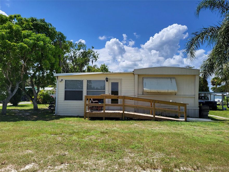 **Fishermen's Haven** This is an income producing property with Airbnb that stays booked! This home is 2 min from the locks to get in on the biggest lake in FL for some of the best bass fishing you could ask for. This 3-bedroom 2 bath with office space and Florida Room that can be used as a 4th bedroom, is in a quiet neighborhood and sits between 2 canals, you can park your boat in the front or pull it up to your dock in the back, next to your back patio. There is plenty of space for storage as there is a shed on the property. This property also has fruit trees that produce every year. The property also has a brand-new septic tank that was put in last year. The home has been converted to be handicap accessible. Call today to for a showing!