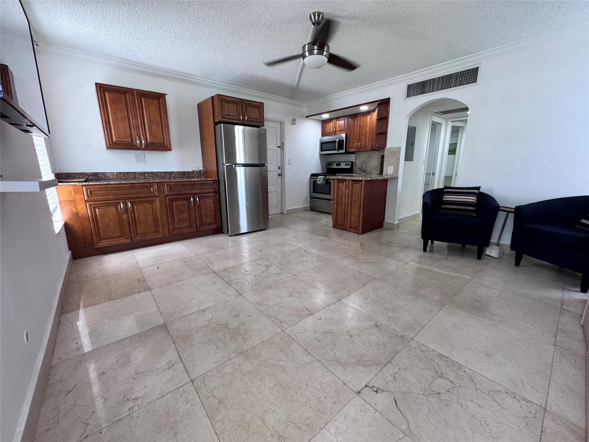 Back on market. Previous Tenants did NOT get approved by HOA. Bright and stylish corner studio in lush Palm Aire Country Club, Pompano Beach. This semi-furnished second-floor unit features marble floors, a large closet, Murphy bed, and a modern kitchen with stainless steel appliances, granite counters, and wood cabinetry. Enjoy landscaped grounds, walking and biking trails, golf course access, and a resort-style pool. Just minutes from Publix, Top Golf, dining, and 3 miles to the beach, with easy access to I-95 and the Turnpike. Rent includes water, trash, and basic cable. One assigned parking space. No pets per association rules. Association approval and 700+ credit score required.