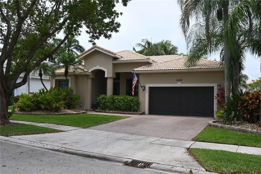 Rarely available single story lake view home within sought after Sandal Cove Subdivision of Pembroke Shores. Recently renovated 2,292 sqft. U/A, 4/3 with 2 car garage & Northern exposure. New Impact doors & windows throughout. A generously covered patio overlooks lake and recently renovated pool & patio. Elegant Interior décor shows like a model. SS appliance suite adorn kitchen cabinetry & granite tops. All recently updated bathrooms, Owner’s primary bedroom features a luxuriously appointed updated en-suite bath, dual vanity sinks, walk-in closet, large soaking bath & walk-in shower. Ceramic & Porcelain tiled flooring, newer A/C & Hot Water Heater, new chandeliers & light fixtures, surround sound wiring in family room, Irrigation System & Ring Doorbell. NEW ROOF UNDER CONTRACT INCLUDED.