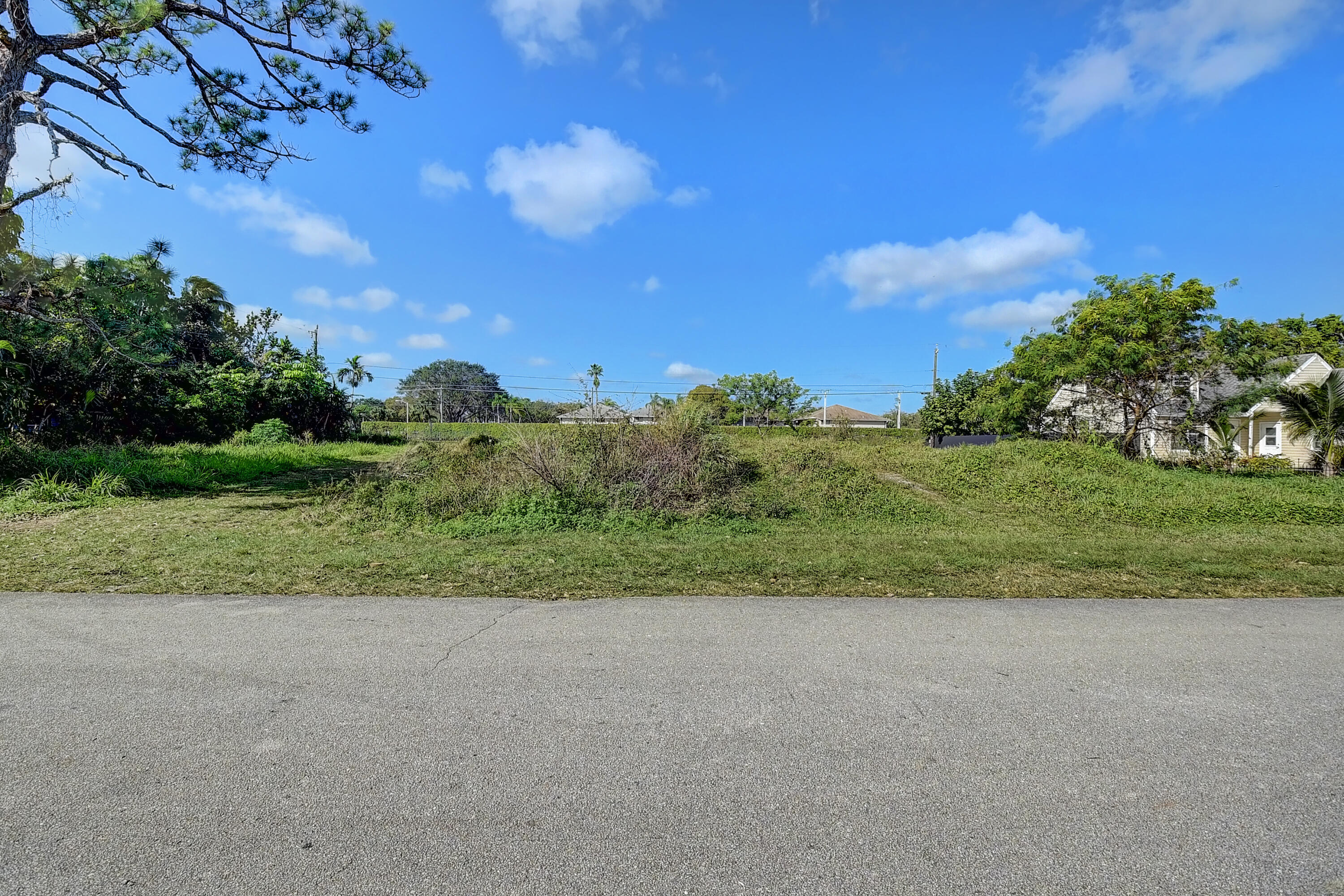 The last double lot in Country Club Acres. A sought after, voluntary HOA community. Lovely park with lake opposite...see last 3 pictures.Bring your boat, truck or RV. Dogs, cats and chickens welcome.This lot CANNOT be split into 2 lots. per PBC Planning and zoning dept.